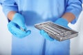 Dentist holding tray with stainless tools, closeup