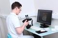 The dentist holds a camera with a ring flash in his hands. The work of a doctor in a dentistry office. Images of teeth on a Royalty Free Stock Photo