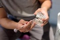 Dentist holds in his hands an artificial plastic transparent jaw