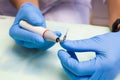 The dentist holds an ultrasonic scaler in his hands