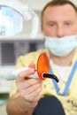 Dentist holds ultraviolet curing light tool
