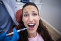 Dentist injecting anesthetics in scared female patient mouth Royalty Free Stock Photo