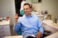 Dentist Inspecting Teeth Of Young Man.