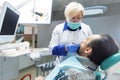 Dentist lady working with patient.