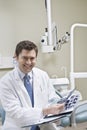 Dentist leafing through medical records Royalty Free Stock Photo