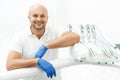 Dentist leaning on the tray of dental instruments Royalty Free Stock Photo