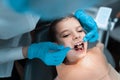 Dentist and little girl patient in the dental office. Child having teeth examined by female dentists Royalty Free Stock Photo