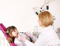 Dentist and little girl patient in dental office Royalty Free Stock Photo