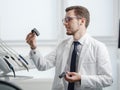 Dentist looking at photopolymer jaw printed on a 3d printer.