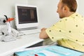 Dentist looks jaw X-rays at computer monitor