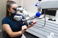 Dentist looks through the microscope. Modern dental equipment.