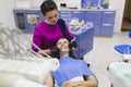 Dentist makes the process of treatment in dental clinic office.
