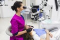 Dentist makes the process of treatment in dental clinic office.