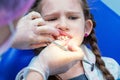 Dentist making teeth examination procedure for little girl sitting on chair in Dentist office Royalty Free Stock Photo