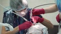 Dentist making tooth cleaning for patient