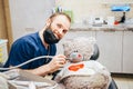 Dentist a man with a teddy bear in the form of a patient in a chair. Royalty Free Stock Photo