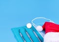 Dentist Merry Christmas New Year Concept Dental Tools And Santa Hat On Blue Background Copy Space. Royalty Free Stock Photo