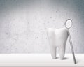 Big tooth and dentist mirror on table Royalty Free Stock Photo