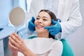 Dentist, mirror and woman check smile after teeth cleaning, braces and dental consultation. Healthcare, dentistry and Royalty Free Stock Photo