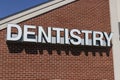 Dentist office exterior with white text and brick background. Royalty Free Stock Photo