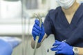 Dentist in office at work. doctor treating tooth of patient in dental chair. hand of doctor with tools for teeth Royalty Free Stock Photo