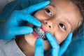 Dentist, Orthodontist examining a little girl patient`s teeth