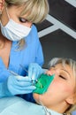 Dentist with patient, cleaning and curing