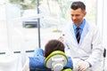 Dentist and Patient in Dentist Office. Young Man in the Dental C Royalty Free Stock Photo