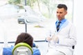 Dentist and Patient in Dentist Office. Young Man in the Dental C Royalty Free Stock Photo