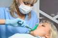 Dentist with patient, installation of rubber dam Royalty Free Stock Photo