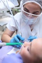 A dentist performs a professional dental cleaning for a small boy. A child in a dental clinic. Professional teeth cleaning. The