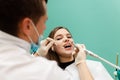 Dentist performs professional polishing of tooth enamel for woman patient