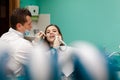 Dentist performs professional polishing of tooth enamel for woman patient