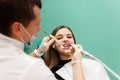 Dentist performs professional polishing of tooth enamel for woman patient