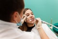 Dentist performs professional polishing of tooth enamel for woman patient