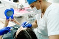 Dentist performs a regular examination of the patient.