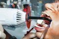 Dentist performs whitening teeth treatment