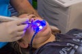 young woman or teenage girl having braces fitted at dentist