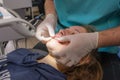 young woman or teenage girl having braces fitted at dentist