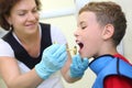 Dentist prepares boy for tooth x-ray image