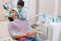 Dentist putting the dental braces on her patients teeth