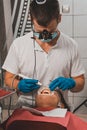 The dentist removes tartar using ultrasound, the patient at the dentist