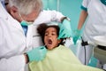 Dentist repairing kid's tooth Royalty Free Stock Photo