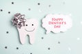 Dentist`s Day greeting card with tooth and speech bubble on a blue