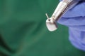 Dentist`s hand in glove with dental handpiece Royalty Free Stock Photo