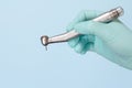 Dentist`s hand in glove with dental handpiece Royalty Free Stock Photo