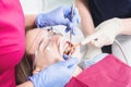 In the dentist`s office. Close-up Examination of the oral cavity of a young female patient by a doctor and assistant Royalty Free Stock Photo