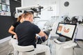 Dentist scanning patient's teeth with modern machine for intraoral scanning.