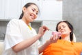 Dentist show dentures to a patient Royalty Free Stock Photo