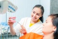 Dentist show dentures to a patient Royalty Free Stock Photo